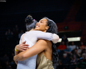 Mya Hooten gives one of her athletes a hug.