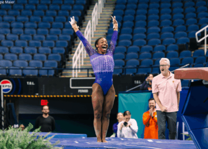 Brie Clark salutes after her vault and smiles.