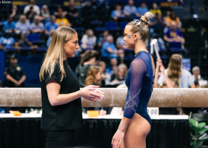 Utah State assistant gymnastics coach Olivia Trautman coaches an athlete during the 2026 Baton Rouge regional