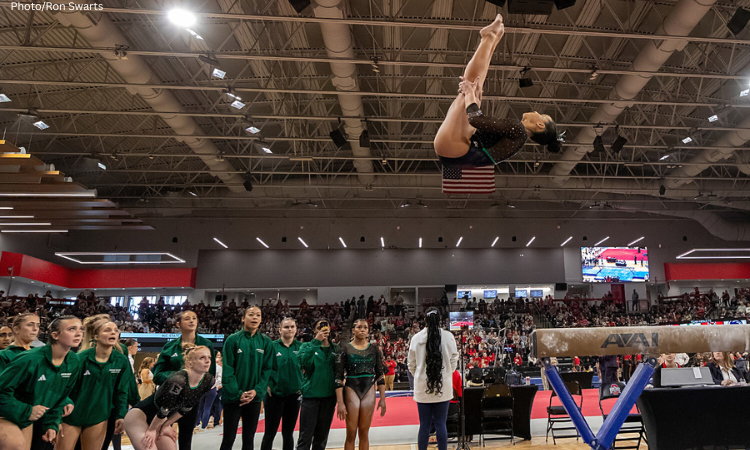Jacqueline Patterson does a gainer pike dismount off the front of the beam. 