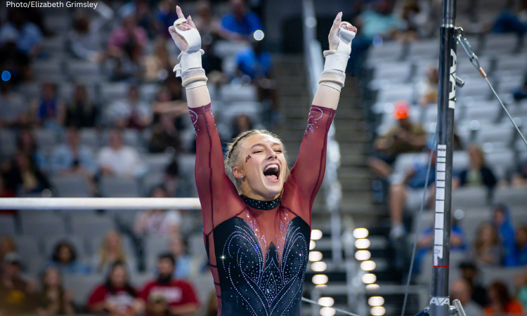 Gianna Gerdes salutes with a victorious expression after her bar routine. 