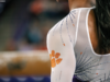 Clemson gymnast stands in front of the beam.