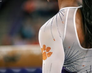 Clemson gymnast stands in front of the beam.