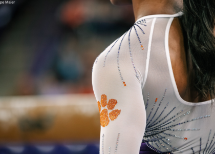 Clemson gymnast stands in front of the beam.