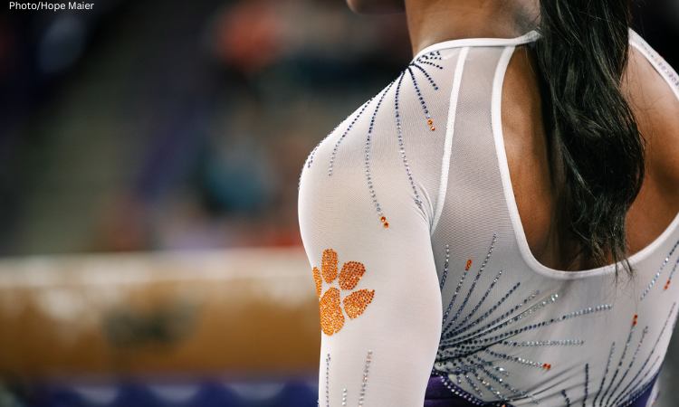 Clemson gymnast stands in front of the beam.