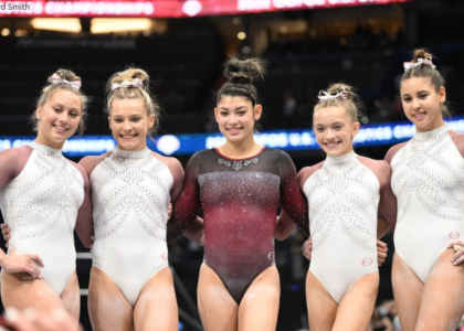 A group of gymnasts pose together