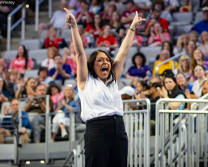 Nicole Jones hold both hands up in celebration.