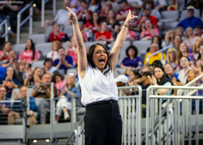 Nicole Jones hold both hands up in celebration.