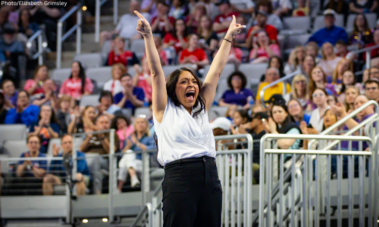 Nicole Jones hold both hands up in celebration.