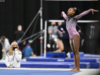 Ariana Barksdale stands in the corner of the floor with both arms up.